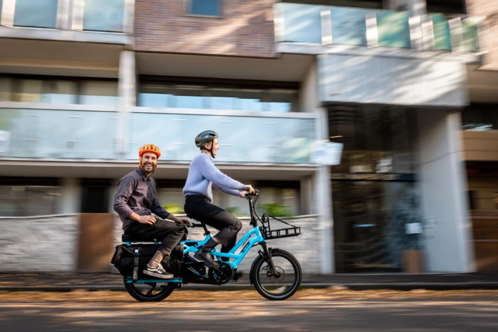 Johanne dinking Joel on a Lug+Carrie ecargo bike. on the streets on Brisbane It's an easy way to get around the city. Dinkin' on a Lug+Carrie electric bike available in Melbourne, Sydney, and Brisbane